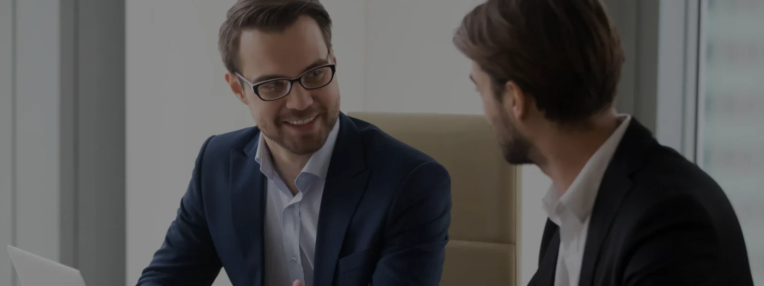 Focused Businessman Listening To Young African American Employee. 1188856985 2125x1416 1@2x