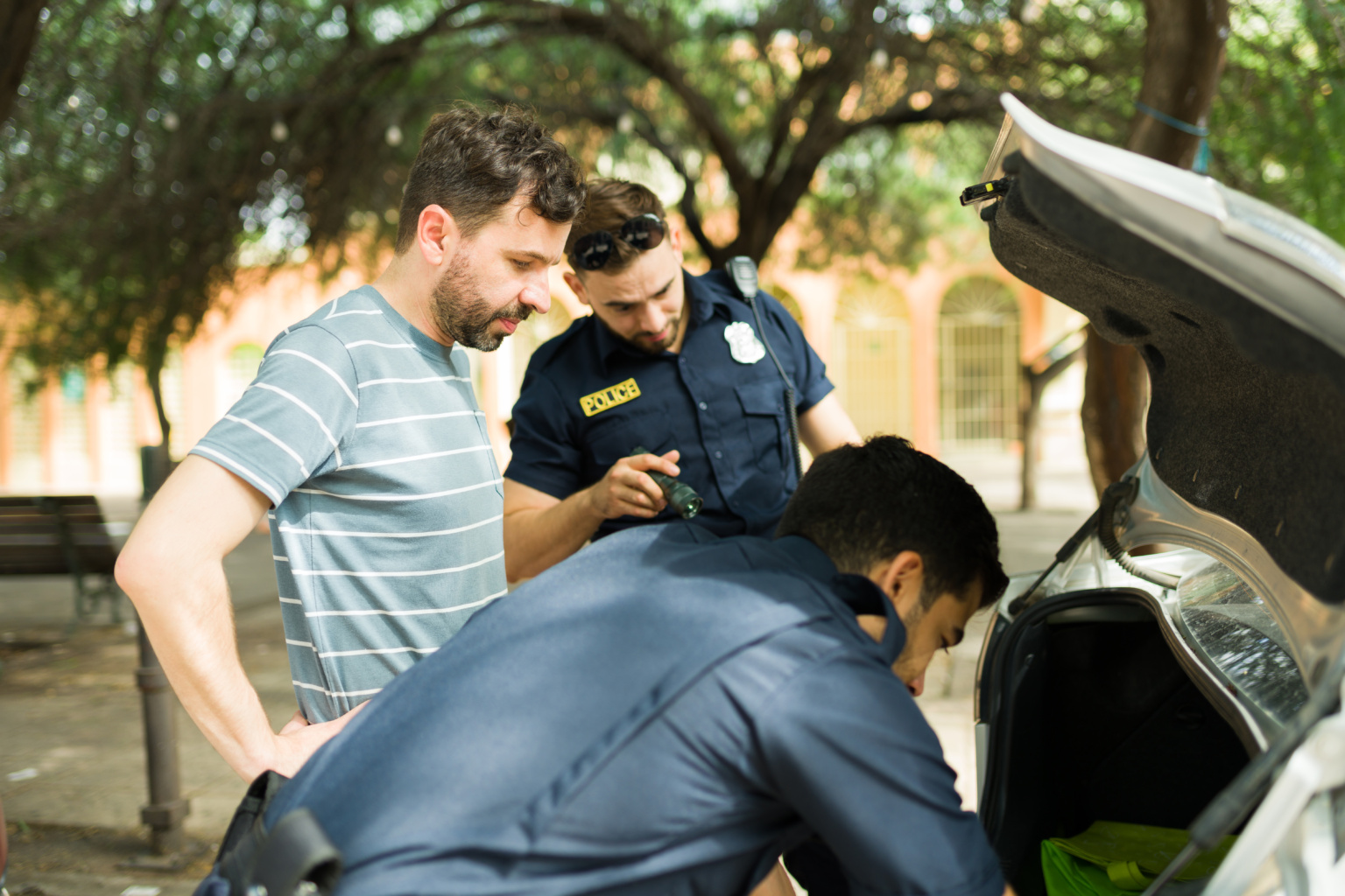 Police Agents Looking For Guns Or Drugs In The Car Trunk